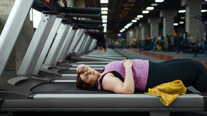 Tired, breathing and fitness gym man taking a break from workout