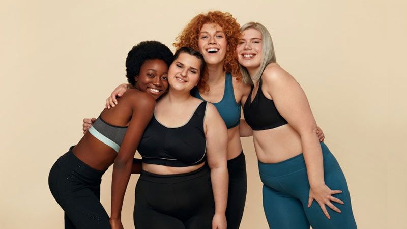 Athletic And Proud, Two Female Friends Stand In Gym Wear Showing Their Fit  Bodies, Types Of Fit Bodies